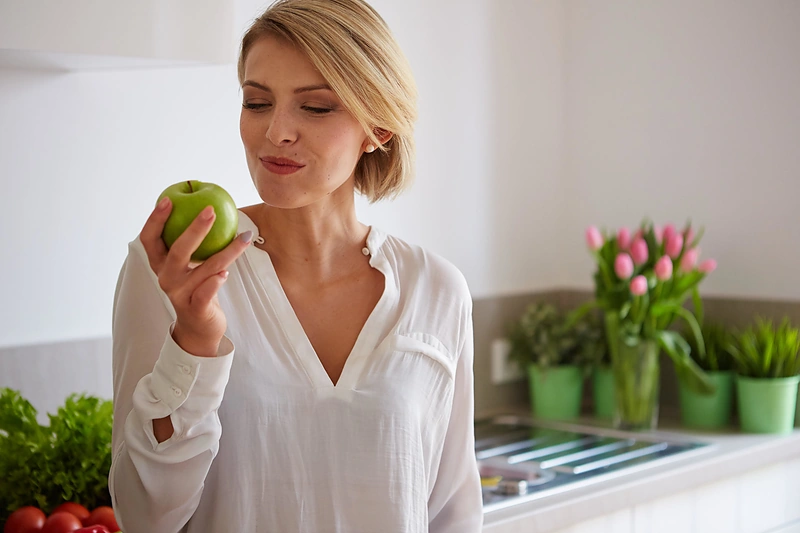 Moteris valgo obuolį